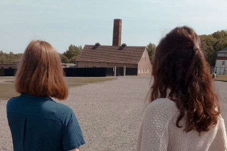 Two volunteers look over the former roll call area at the Buchenwald memorial site