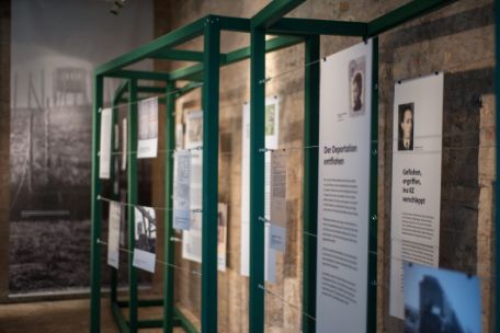 Metal frames hold wires from which informational texts hang. 