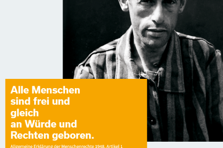 A banner with a photo of a man dressed in prisoner's clothing. In front of it is the text "All men are born free and equal in dignity and rights." Below it the announcement of the 75th anniversary of the liberation. 